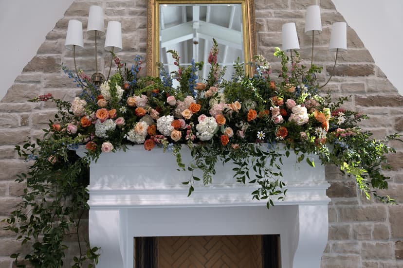 Flowers running the length of a stone mantel