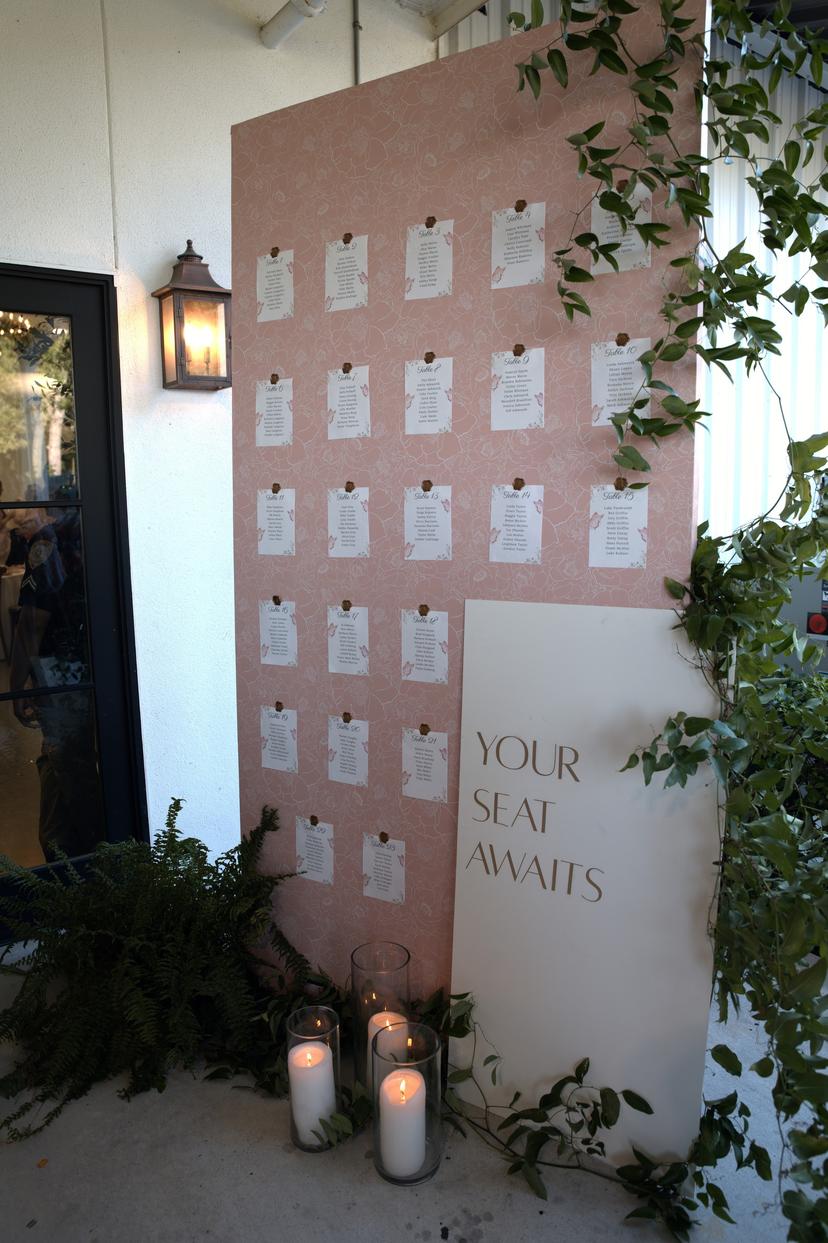 The seating chart by the door, lit by candles