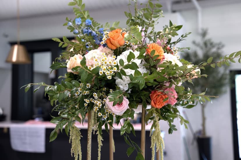 A raised arrangement with amaranthus hanging from it