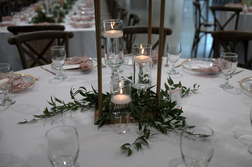 Brass tapers standing over trailing greenery