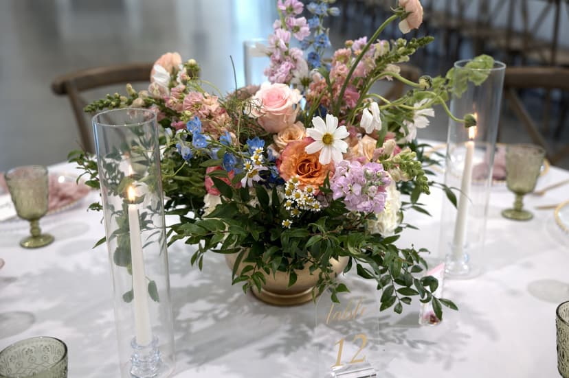 A wildflower centrepiece standing between tapers